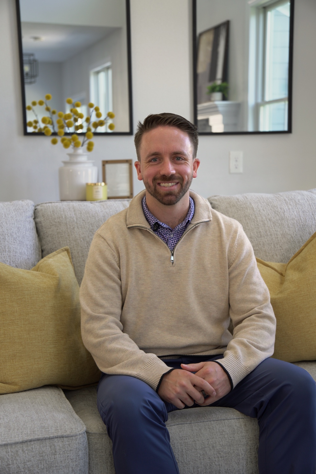 Drew Messer seated on a couch